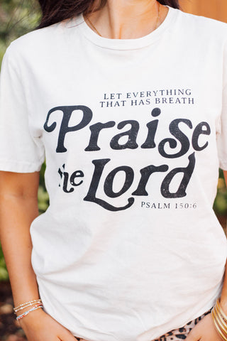 Close-up of "Praise the Lord" Psalm 150:6 graphic tee in white with bold black lettering—faith-based apparel from Makenzie Layne Boutique