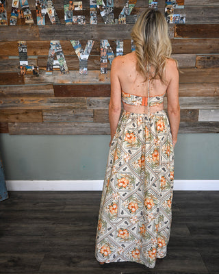 Women’s floral halter maxi dress with open back detail, smocked band, and tropical-inspired print for a breezy boho boutique look