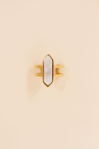 Gold double band ring featuring a large geometric white druzy stone set in a pointed bezel setting. Statement ring with a modern, boho-inspired design perfect for everyday or dressy wear.