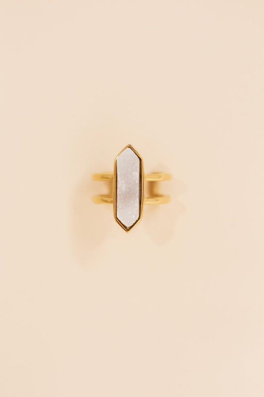 Gold double band ring featuring a large geometric white druzy stone set in a pointed bezel setting. Statement ring with a modern, boho-inspired design perfect for everyday or dressy wear.