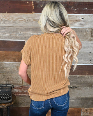 Women’s camel brown textured short sleeve knit top with a relaxed fit, styled with dark wash denim for an effortless casual fall boutique look.