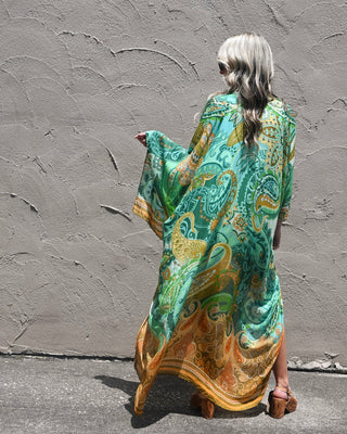 Women’s oversized green paisley kimono duster with flowy boho silhouette and earthy tones, perfect for layering over summer outfits and resort looks.