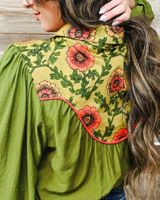 Olive green western blouse with a bold coral floral print yoke, contrast piping and flowy long sleeves for a feminine, vintage-inspired boutique look.