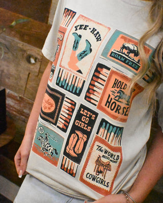 Western graphic tee featuring vintage cowboy matchbox artwork, cowgirl sayings, boots, horses, and rodeo-inspired graphics for trendy western boutique style.