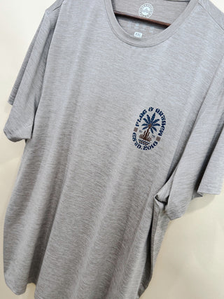 Men’s light gray performance t-shirt with small palm tree and Flag & Anthem logo detail on chest, displayed hanging in boutique. Breathable and casual fit.