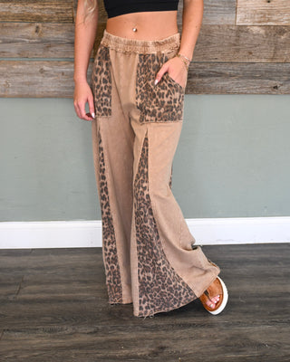 Women’s mocha wide leg lounge pants with leopard print panel detail, elastic waistband, front pockets, and relaxed flowy fit for an edgy boutique look