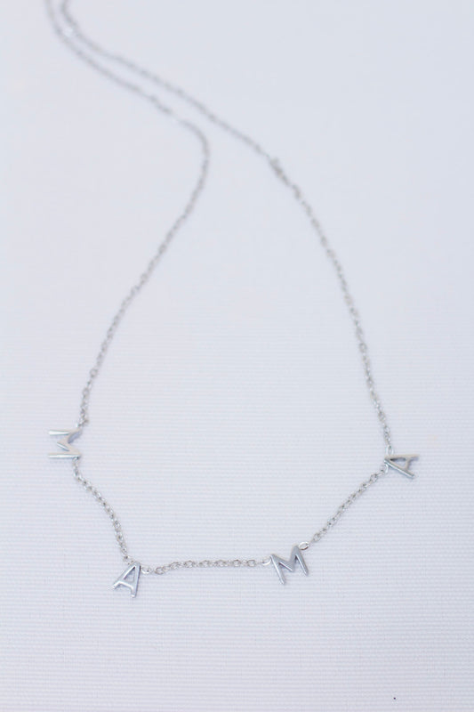 Delicate silver chain necklace featuring individual letter charms that spell 'MAMA'. Minimalist and meaningful jewelry piece, perfect for Mother's Day or everyday wear.