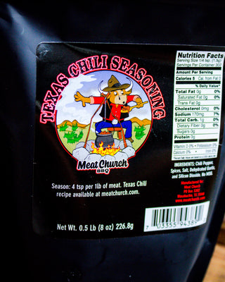 Meat Church Texas Chili Seasoning packaging with a cartoon bull and bear character on a black background