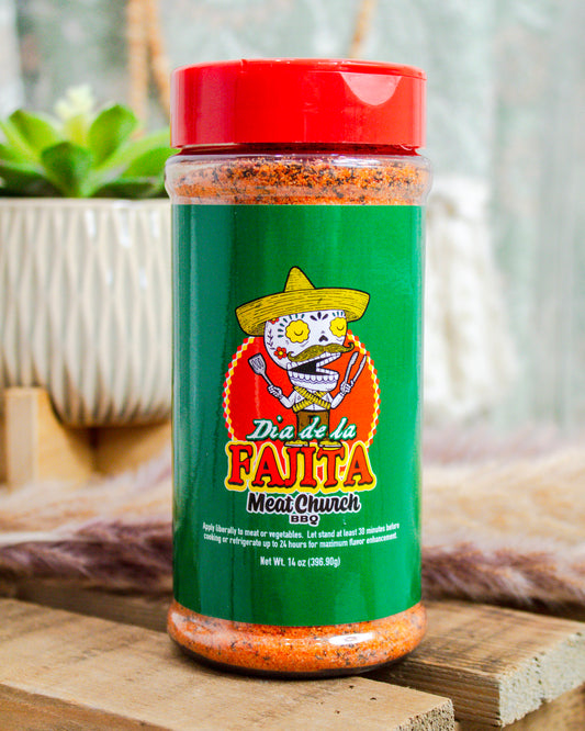 Meat Church Dia de la Fajita BBQ rub, 14 oz bottle with green label and festive skeleton graphic—bold Tex-Mex seasoning at Makenzie Layne Boutique