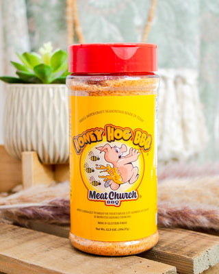 Meat Church Honey Hog BBQ seasoning rub, 12.5 oz bottle with bright yellow label and cartoon pig—sweet Texas BBQ flavor at Makenzie Layne Boutique