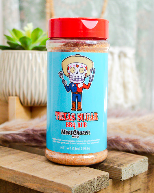 Meat Church Texas Sugar BBQ Rub, 12 oz bottle with blue label and skeleton cowboy graphic—sweet Southern seasoning available at Makenzie Layne Boutique