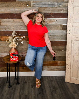 Bright red basic tee with relaxed fit, styled with distressed cropped jeans and sandals—casual boutique outfit, everyday essential top, comfy and versatile women’s fashion