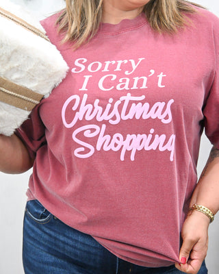 Women’s maroon graphic T-shirt with the text ‘Sorry I Can’t Christmas Shopping.