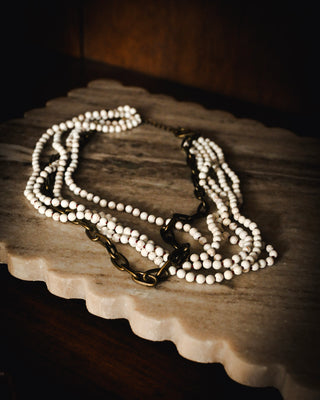 Layered white howlite beaded necklace with mixed antique gold chain accents, blending boho texture with chic western-inspired statement style.