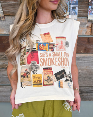 Women’s cream western graphic muscle tee with “She’s a Small Town Smokeshow” vintage rodeo print, styled with olive embroidered shorts for a playful boutique look