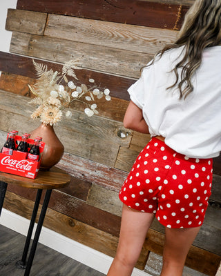 women’s red polka dot high waisted shorts, retro patriotic summer shorts, lightweight boutique bottoms styled with graphic tee, Memorial Day outfit back view