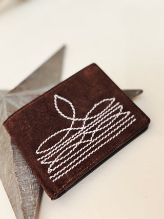 Handcrafted brown suede wallet with white western rope stitching, rustic men's accessory on neutral background.