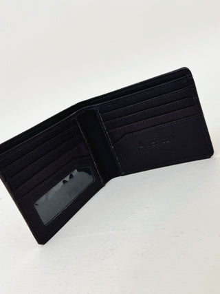Open black leather bifold wallet with multiple card slots and clear ID window, minimalist men's wallet by American brand on white background.