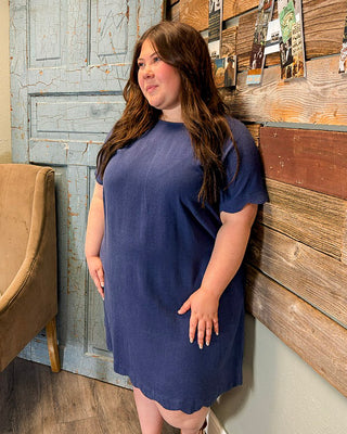 Plus size navy blue short sleeve dress with scalloped hem and relaxed fit, perfect for comfortable everyday wear