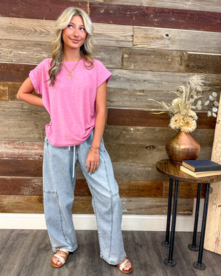 Women's bright pink relaxed fit tee paired with light wash wide leg drawstring denim pants, featuring a casual summer outfit, comfortable fit, and boutique style.
