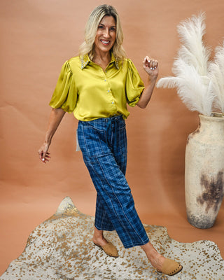 Women's chartreuse satin button-down blouse with rhinestone embellished collar and puff sleeves, styled with blue plaid wide leg cropped pants for a polished boutique outfit perfect for work, brunch, parties, or date night.