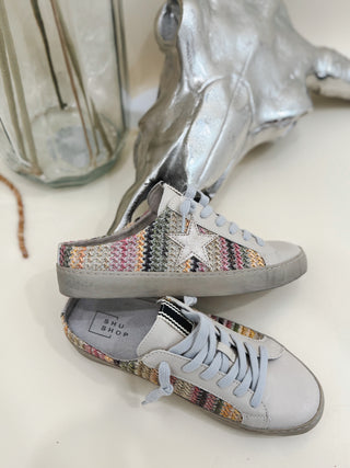 Women's SHU Shop sneakers with multicolor knit sides, silver star detail, and light grey laces. Trendy casual shoes perfect for everyday wear.