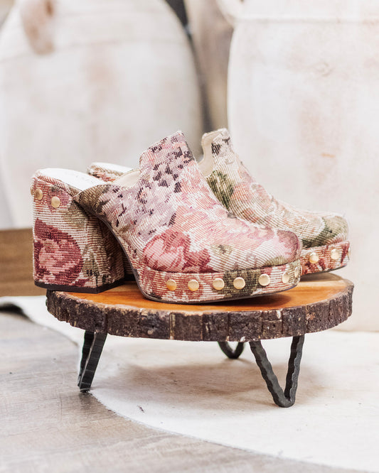 Close-up of brown and pink floral tapestry heeled mules with gold studs