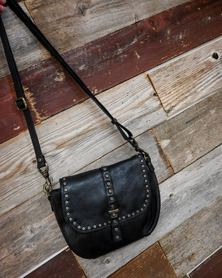 Black studded crossbody handbag with adjustable strap and silver-tone hardware, featuring a chic western-inspired design perfect for everyday wear, concerts, casual outfits, and boutique fashion styling.