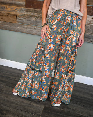 Women’s sage floral wide leg pants with smocked waistband, tiered silhouette, and boho print detail for an effortless boutique look