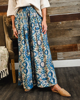 Women’s blue boho floral wide leg pants featuring an intricate vintage-inspired print, flowy silhouette and elastic waist for effortless everyday style.